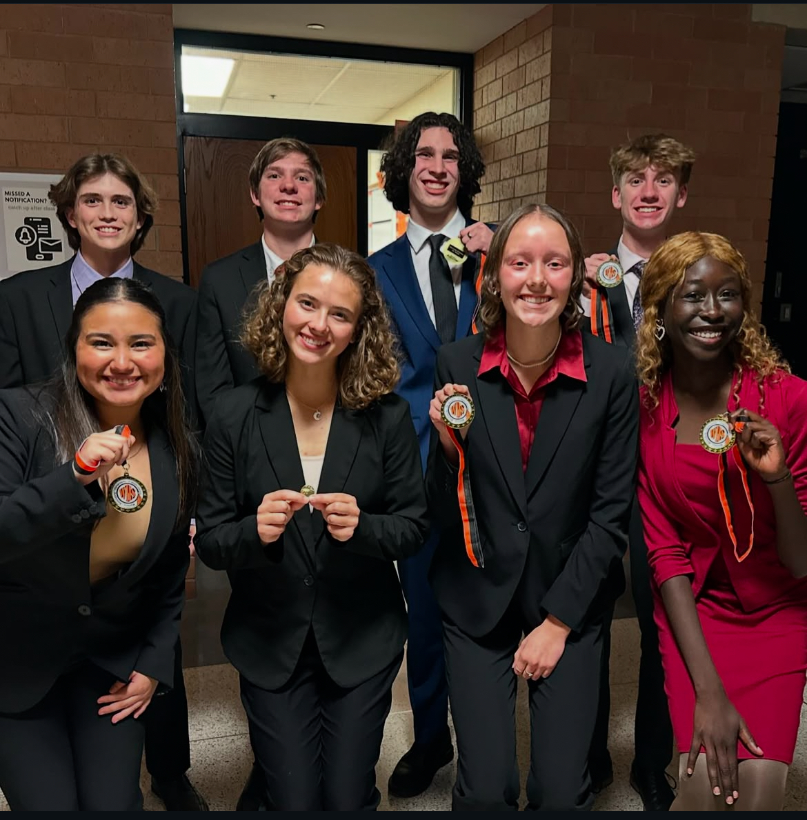 Oral Interp group posing for a photo with their medals after the Washington Invite 